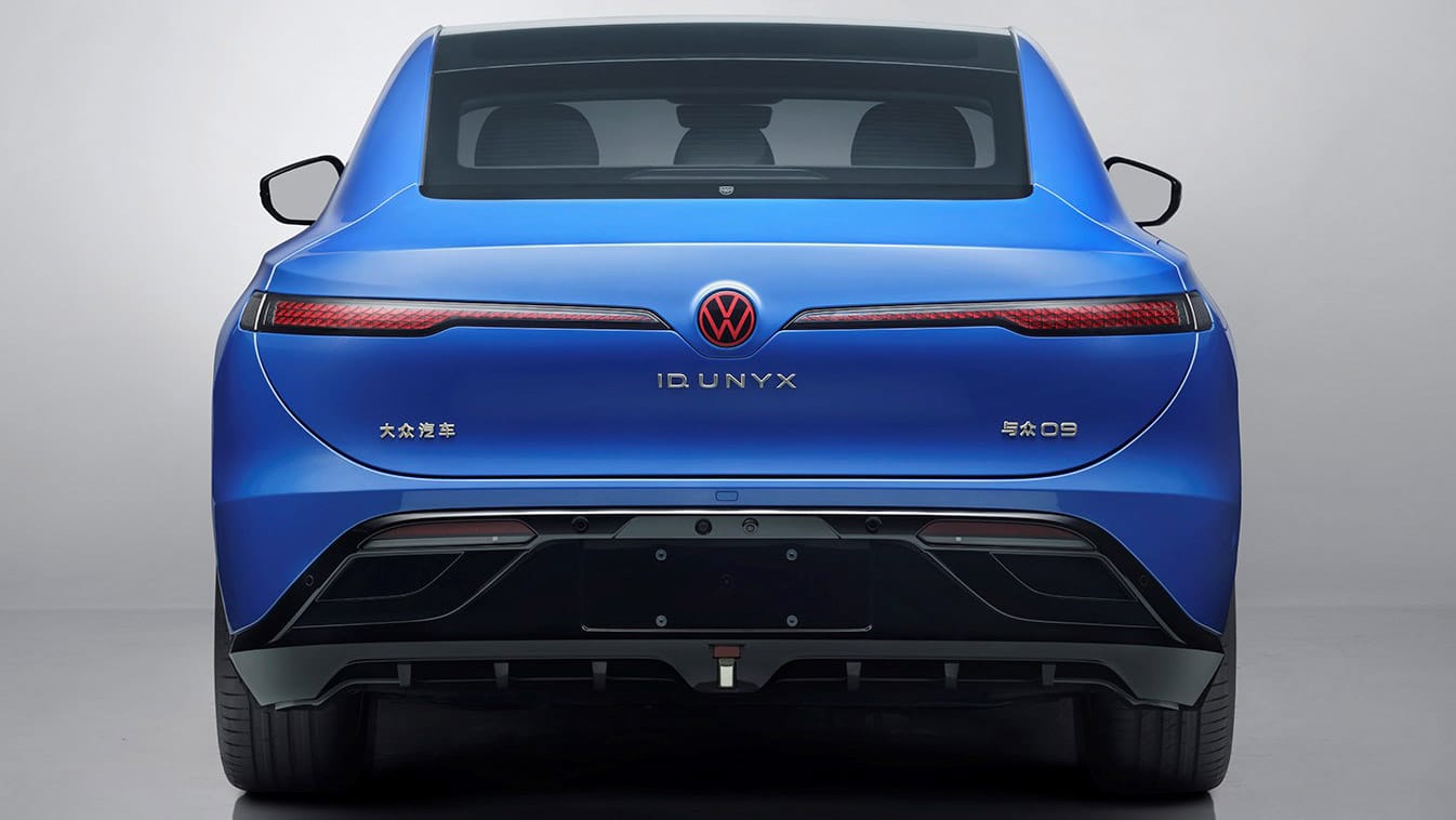 Rear view of the blue Volkswagen ID. UNYX 09 electric sedan with illuminated VW badge and ID. UNYX lettering